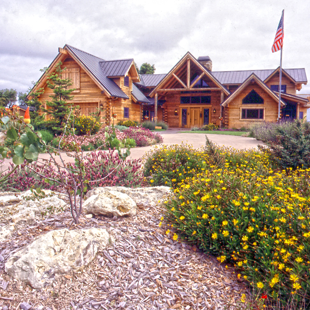 Log Home Exterior With Stone Landscaping