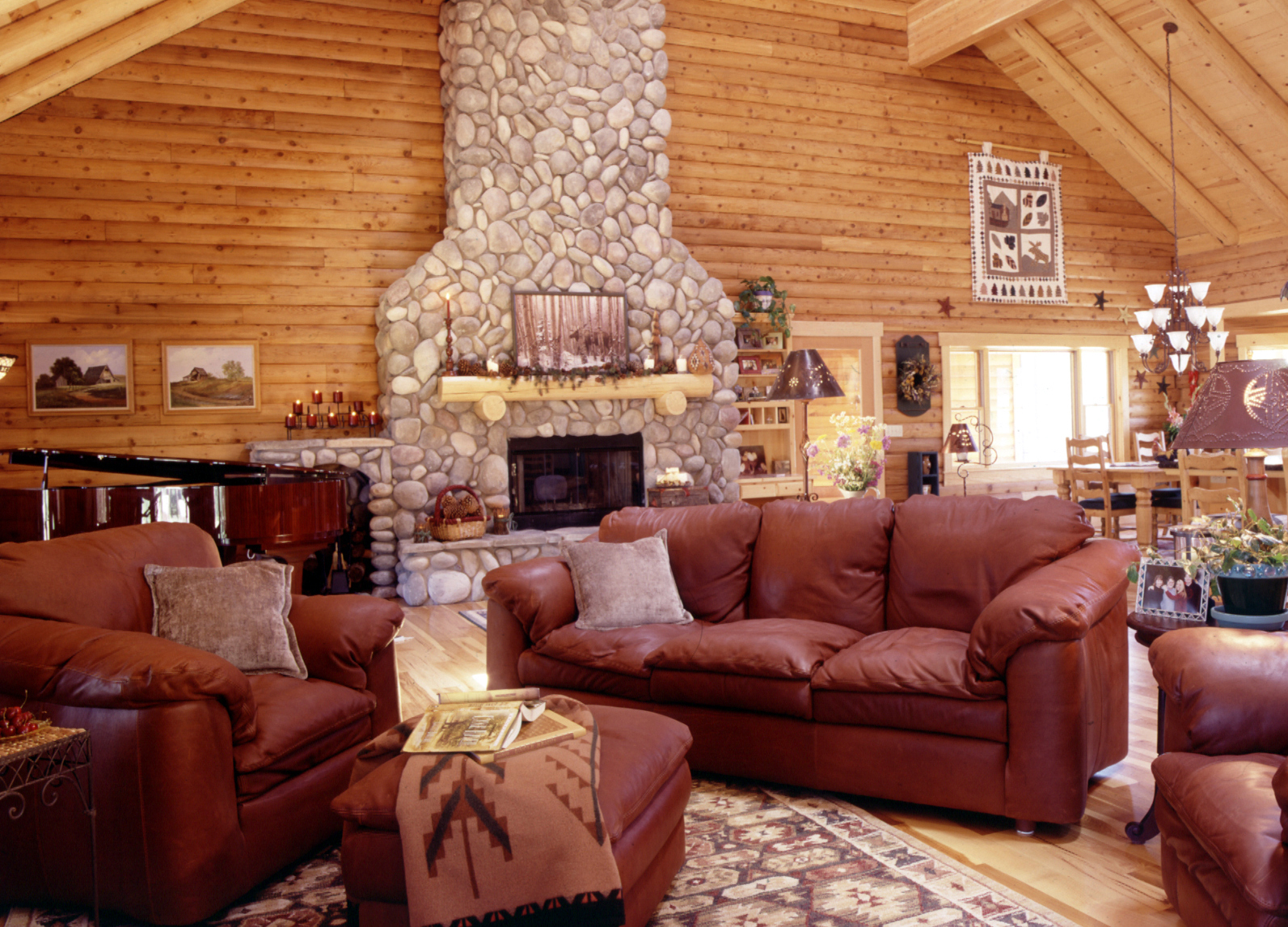 log home great room with leather sofa